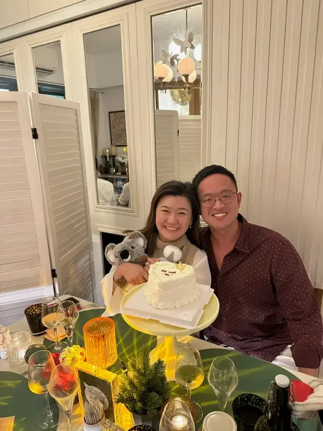 Anna and John celebrating together with a cake and a koala keepsake